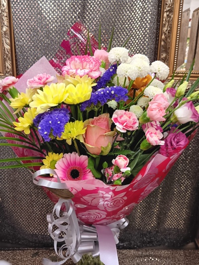 Rainbow Wishes - A bright and colourful wrap bursting with pink, yellow, purple and white tones, beautifully handcrafted by City Florists in Inverness.